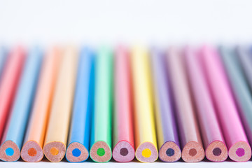 Bright colored pencils in a blurred form. The image is blurred. Background of colored pencils. Selective focus. A place for a label.