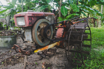 Fototapeta premium The hand tractor is parked on the garden in rural Thailand.