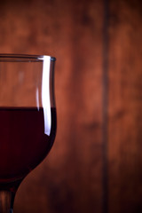  A glass of red wine on an old wooden rustic background