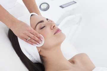 Young woman in beautician having a facial cleaning.