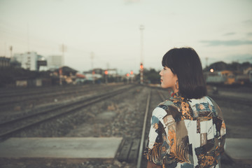 Portrait of asian hipster girl on sunset at railway vintage  style