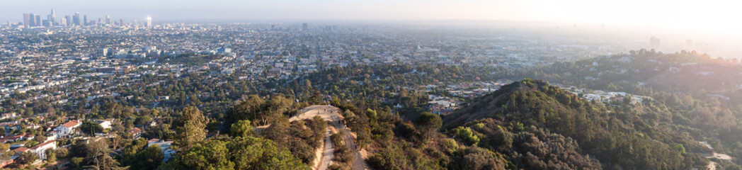 Panoramic view of the city of Los Angeles and surrounding area in hazy sunlight lens flare
