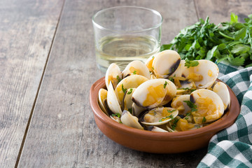 Clams with marinera sauce.Almejas a la marinera. Spanish recipe on wooden table