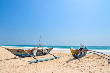 Two fishing boats on the ocean shore