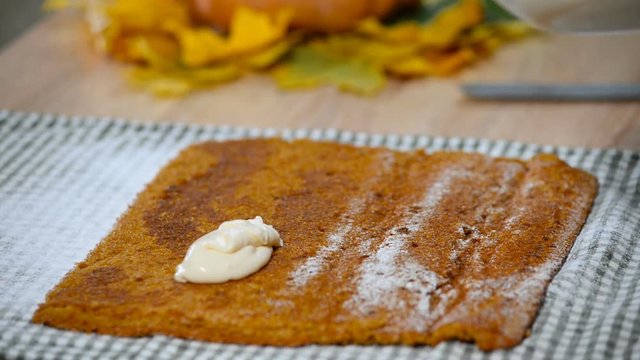 Cooking Pumpkin roll with the cream.