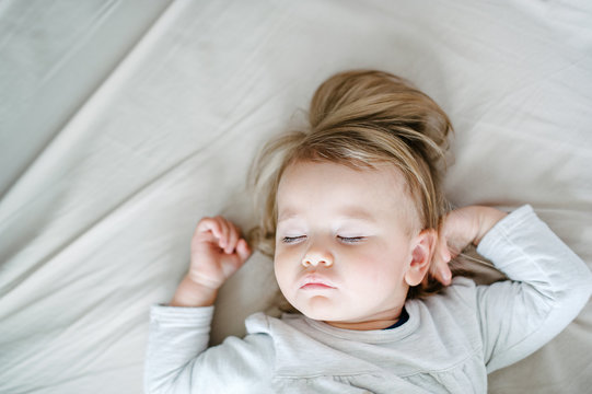 Beautiful toddler sleeping in bed