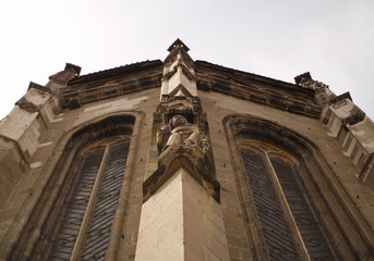 Fototapeta premium Stone statue seen from below - Gothic style decoration