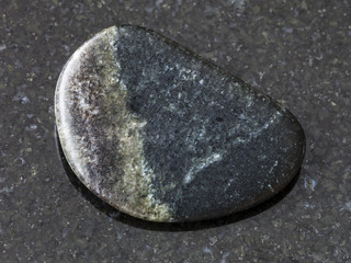polished Olivenite stone on dark background
