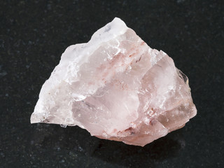 raw crystal of rose quartz gemstone on dark