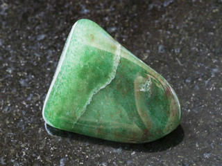 polished green aventurine gem stone on dark