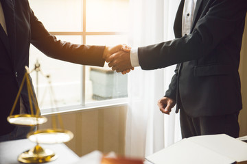Fototapeta premium Handshake between attorneys and clients after agreeing to enter into a contract for a court case. In the hope of victory over legal fighters.