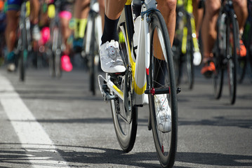 Naklejka na ściany i meble Cycling competition,cyclist athletes riding a race,detail cycling shoes