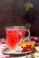 Useful vitamin tea from berries of the viburnum with honey with glass cups.
