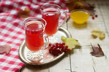 Useful vitamin tea from berries of the viburnum with honey with glass cups.