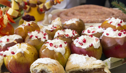 Stuffed apples with white cream and decorated with pomegranate seeds