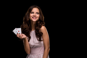 Sexy curly hair brunette posing with chips in her hands, poker concept black background
