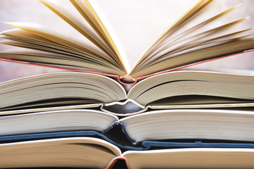 Several textbooks with white sheets opened in the middle