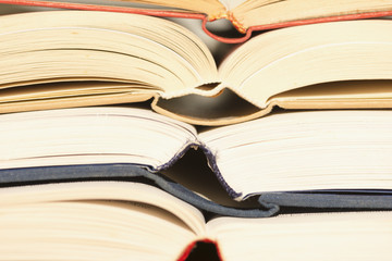 Several textbooks with white sheets opened in the middle