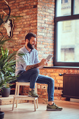 A man using tablet PC in a room.