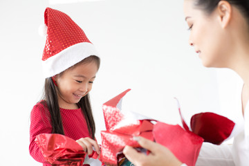 Attractive Asian Girl received a present at brithday with her family. Kid holding Gift with Attractive smiling. Kid with Happy Emotion.