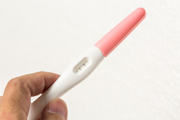 Hand holding pregnancy test