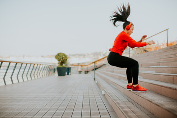 Young woman exercising jumping outside