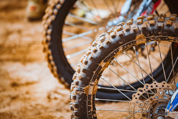 Close-up of front wheels of mountain off-road motorcycle on a start line