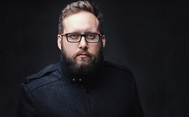 Fototapeta premium Serious plump male in eyeglasses over grey background.