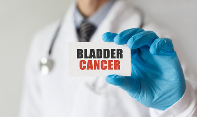 Doctor holding a card with text Bladder Cancer, medical concept