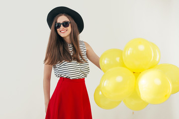 Young pretty woman with yellow balloons
