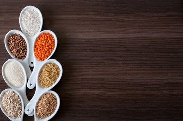 Cereals in a white dish on a dark wooden background