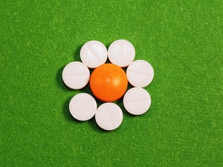 Eight tablets on a green background