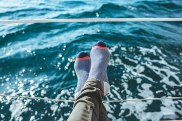 Closeup on women's feet in socks on the yacht, lifestyle, pleasure concept.