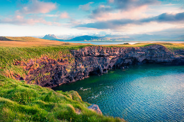 Typical Icelandic landscape with volcanic mountains and Atlantic ocean coast