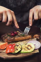 grilled beef steak with sauce and vegetables