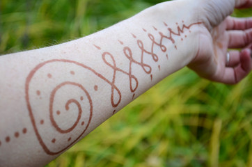 Ornament henna on forearm