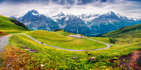 Dramatic summer panorama with a Grindelvald village in tha valley.