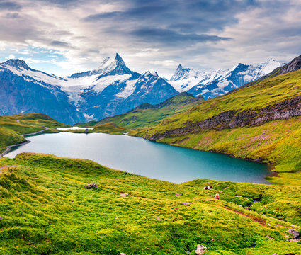 Dramatic summer view of the Bachalpsee lake with Schreckhorn and Wetterhorn peacks on the background.