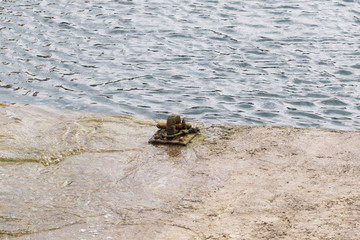 rusty ring for the mooring of a fishing vessel in port
