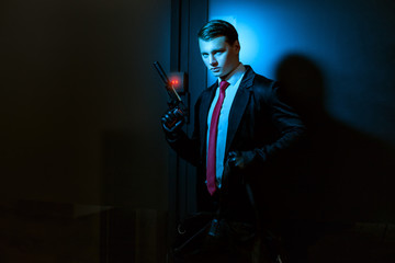 Man wearing gloves and with a gun.