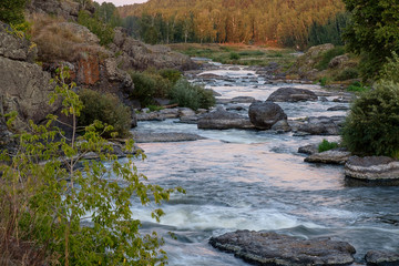 the rapids on the river running in the forest among the rocks