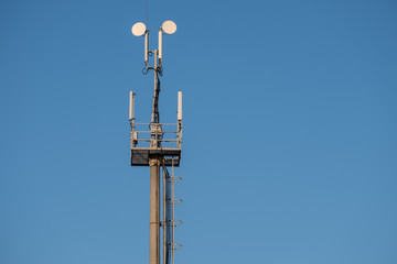 a cell phone tower in the blue sky