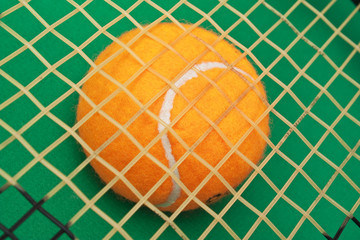orange tennis ball on  green background