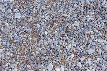 Detail of beach in greece made of small pebble stone texture