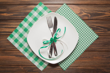 Festive table knife and fork on a brown wooden background St.Patricks Day