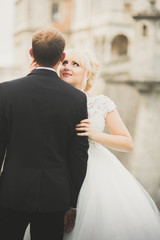 Fototapeta premium Kissing wedding couple in spring nature close-up portrait