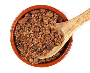 Crunchy granola, muesli pile with chocolate isolated on white background, top view