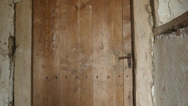 Abandoned house doors close-up slow tilt footage - Tilting on rotten wooden planks and rusty lock details