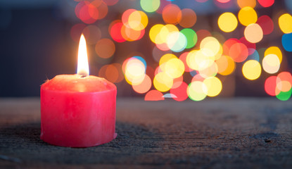 Obraz na płótnie Canvas Christmas Candle over blurred christmas Bokeh background,Space for text.