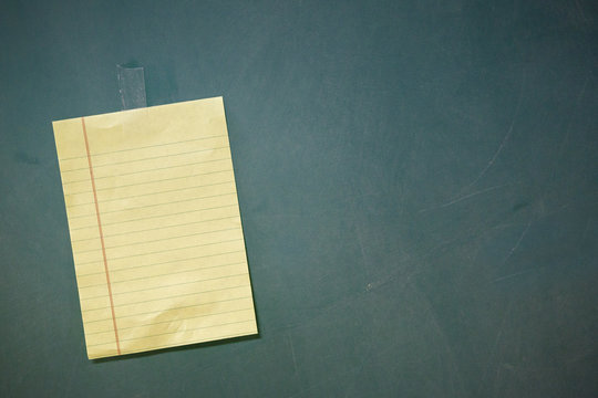 note taped to chalkboard left tilt